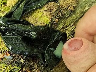 Outdoor cumshot in a used condom in the forest