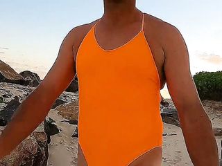 Orange one piece swimsuit down at the beach