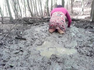 in a mini dress she is playing in the mud