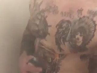 Tattooed muscle soldier in the shower