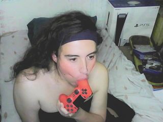 Cute cd girl, beautiful eyes and face. Kissing, licking and sucking a playstation controller. Sweet cd girl next door.