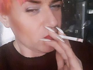 transvestite Sonyastar smokes, long nails, red hair