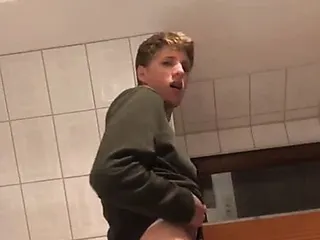 A gay man from Germany jerks off his big dick in the bathroo