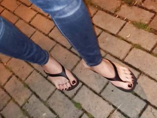 a crossdresser with beautiful feet walks the street and seduces in sexy flip-flops
