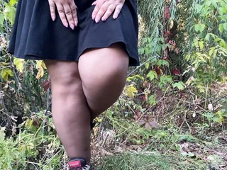 MILF in dress and torn pantyhose pissing outdoors