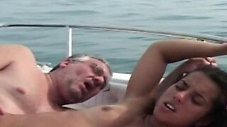 A young brunette gets fucked by an old pig on a boat