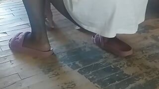 Woman in hijab wipes the floor in the village house