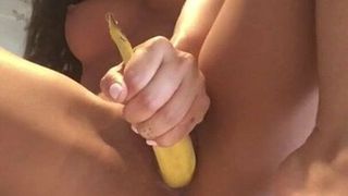 Asian babe masturbates her pussy with a banana