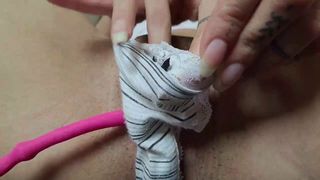 naked woman uses vibrator on her pussy