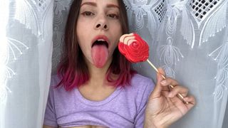 Naughty stepsister sucks a lollipop and show her long hot sexy tongue