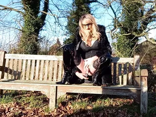 Tranny dildoing on a bench outdoors...