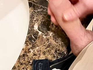 A bit of fun in the office bathroom ending with cum