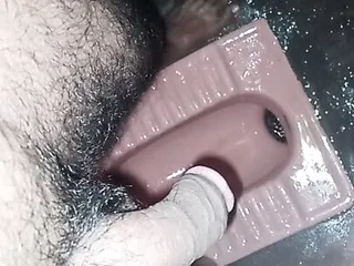 Boy pissing in the toilet...