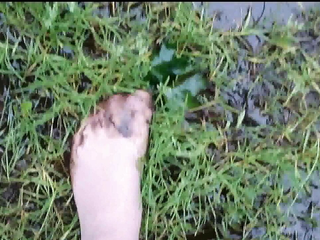 Nylon feet have fun in the dirty puddle