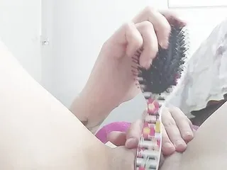 Hottie sticking brush in pussy...