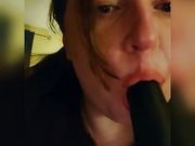 Sucking a big black dildo