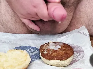 adding some gravy to my sausage and biscuit