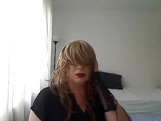 horny MILF tranny in front of the webcam plays with a vibrator simulating Blowjob