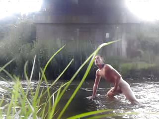 Wild teen taking bath in a river