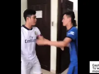 Two asians wearing soccer uniform have...