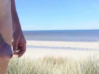 Nude walking through the Dutch dunes