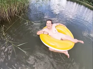 Playing With A Water Donut Naked In The Lake